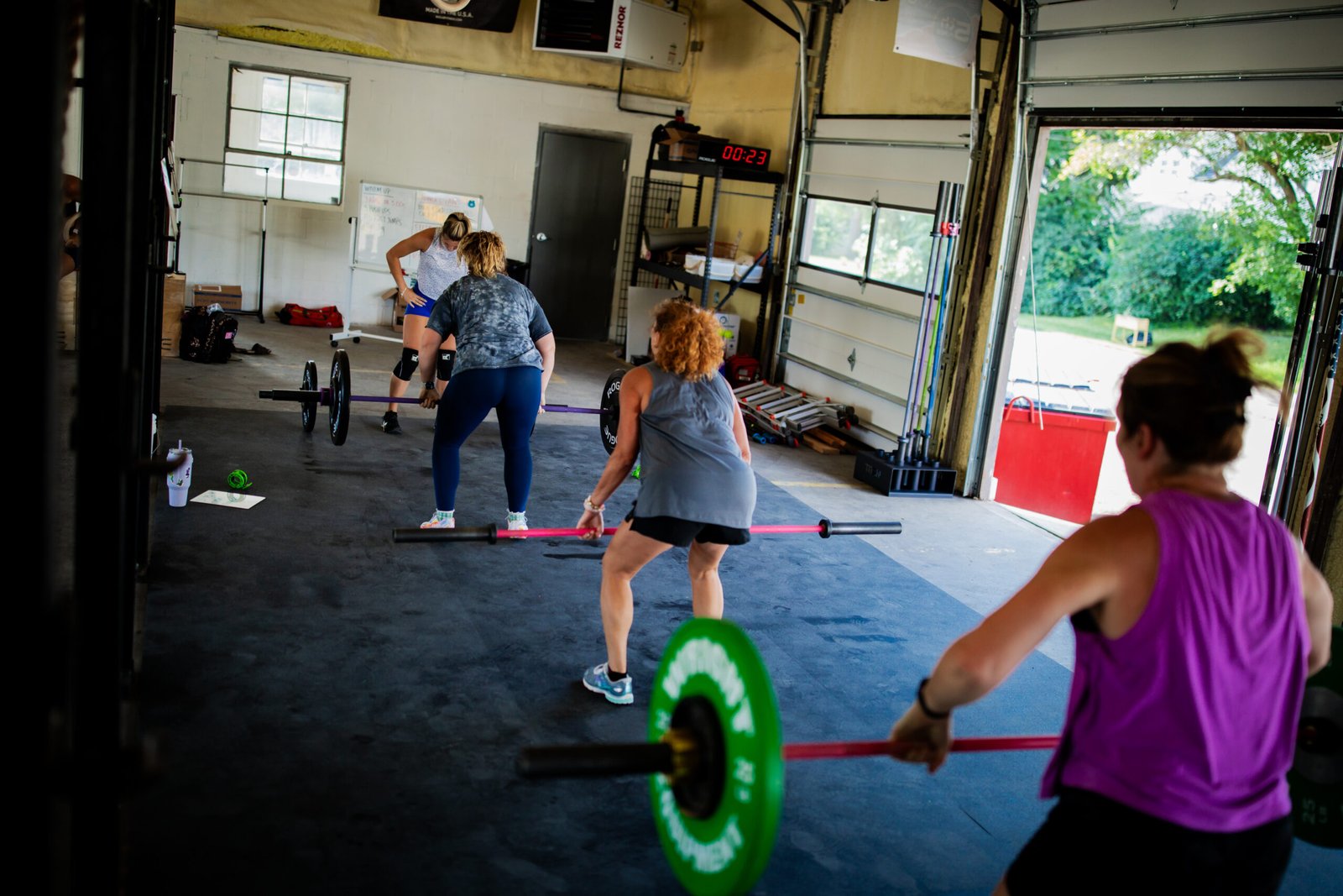 Group CrossFit class lifting weights during a coach-led workout at Arc Reactor CrossFit in Zanesville