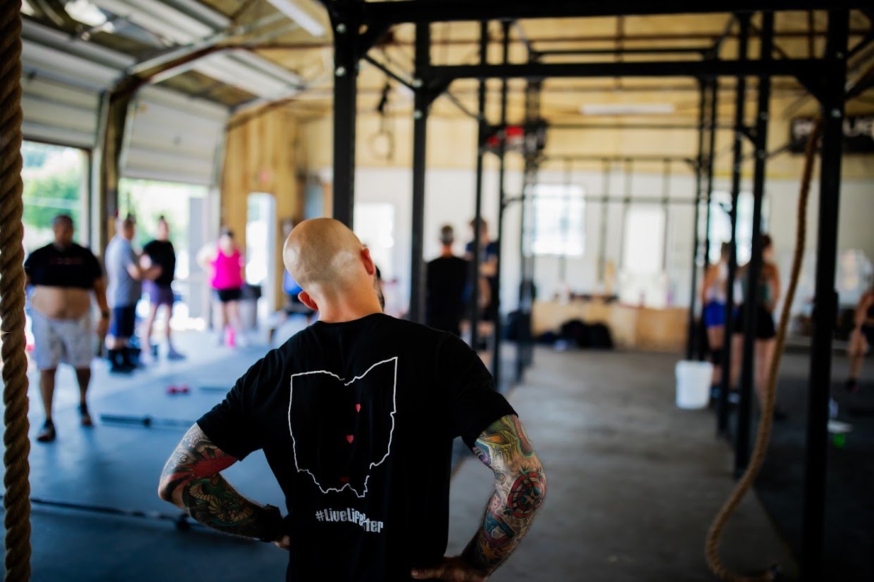 Coach helping members at Arc Reactor CrossFit gym in Zanesville