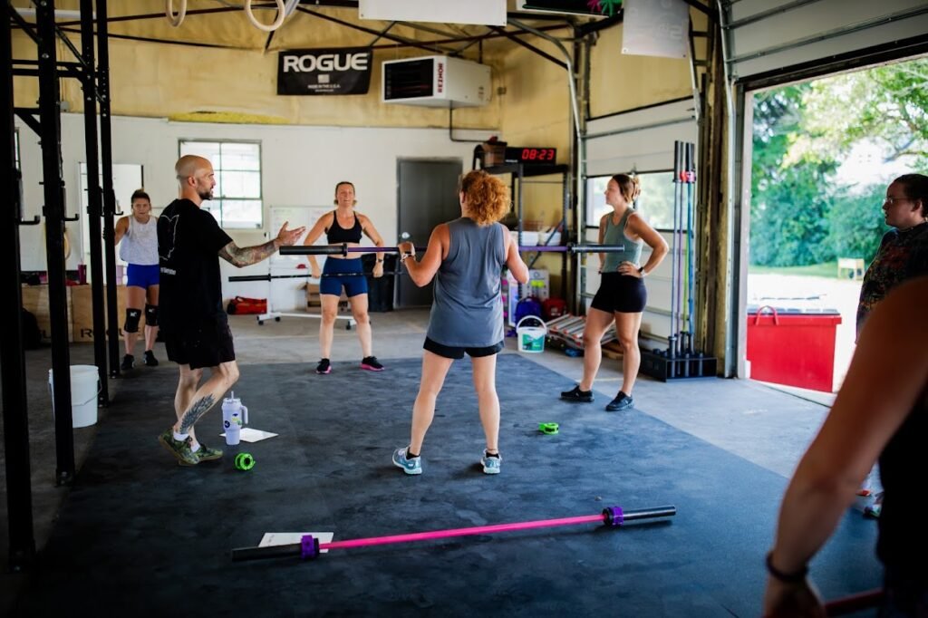 Coach instructing members through the power clean.