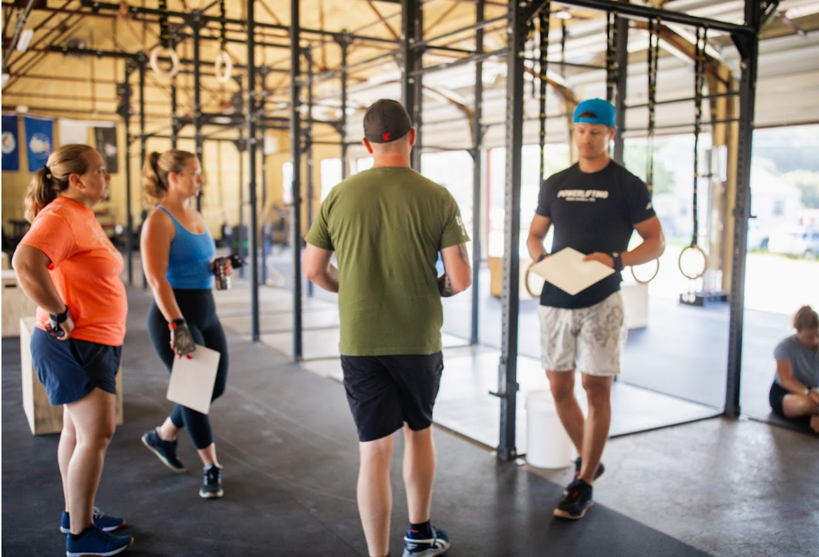 Coach providing guidance and encouragement to a gym member during training